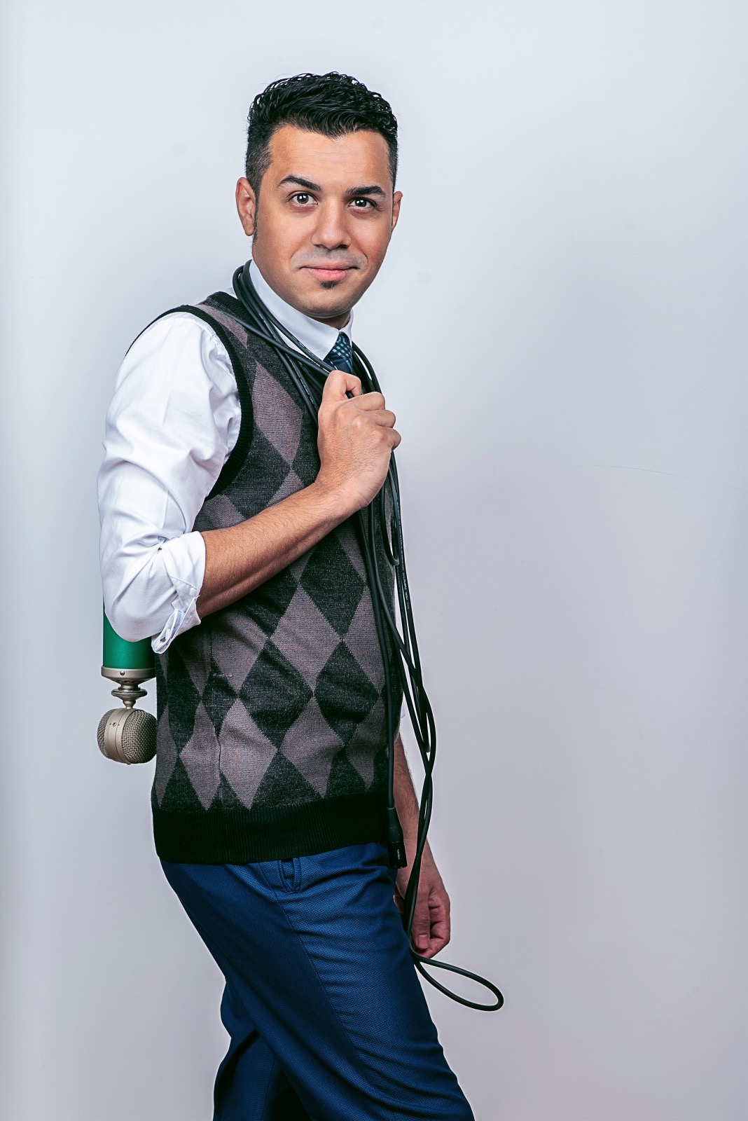 Hussain Alarab with a microphone and cable over his shoulder