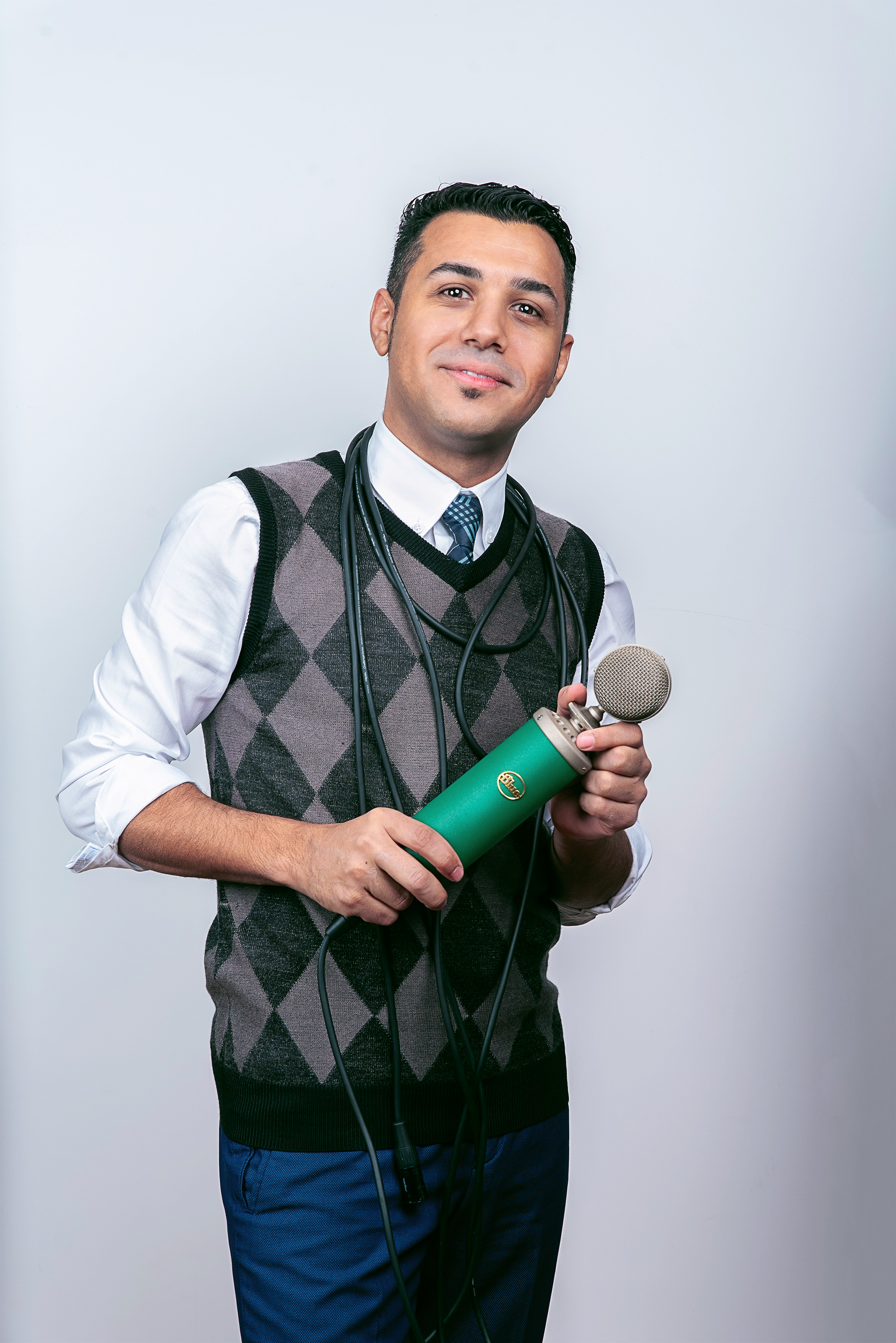 Hussain Alarab working with a microphone in a studio